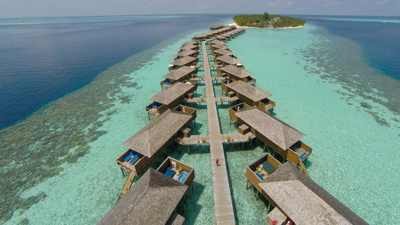 Crystal-clear lagoon and overwater bungalows in Taha'a Island